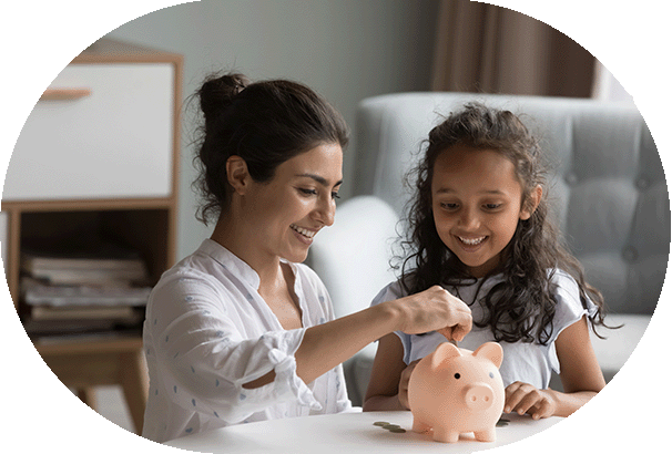 Woman and daughter saving money into a piggy bank